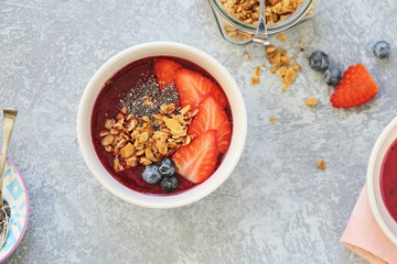 Smoothie bowl. Berrie smothie with chia seeds, granola and blueberry topping. Super food, clean eating,plant based concept. Copy space
