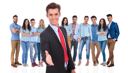Obraz premium young businessman welcomes you to his team with a handshake