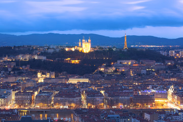 Aerial view of Old town with Fourviere cathedral during evening blue hour in Lyon, France