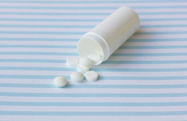 Pills medication on a medical blue background.
