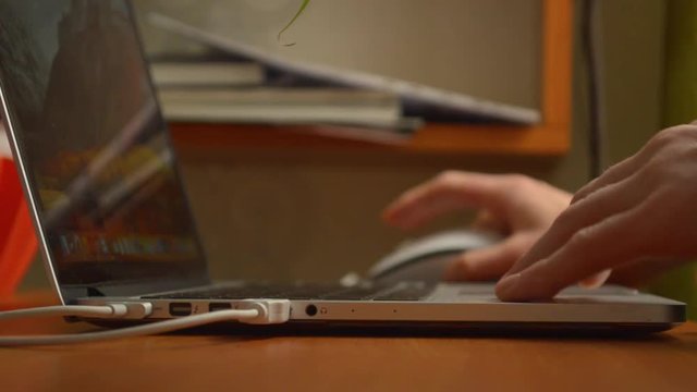 Person opens, works on and closes laptop netebook, sidebar jack closeup