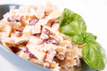 Pasta salad with cheese, ham, kidney beans and mayonnaise