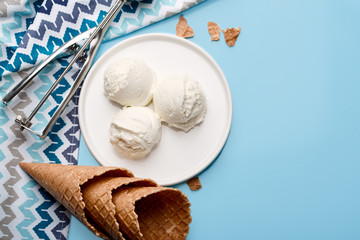 Ice cream balls, scoops and waffle cones on dark background. Advertising space.