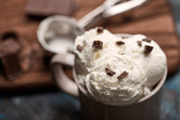Ice cream balls, scoops and waffle cones on dark background. Advertising space.