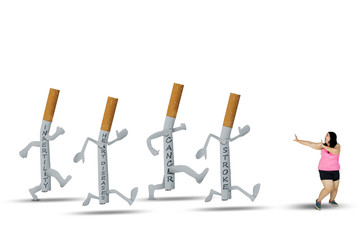 Overweight women running away from cigarettes