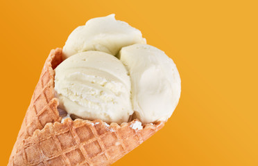 ice cream balls with colored sugar sprinkles in a Waffle Cone on a yellow Background. Vanilla ice cream in a waffle cone.