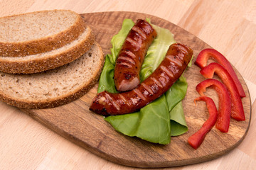 breakfast with sausage on a wooden board with mango