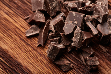 crumbs of black chocolate on a wooden background