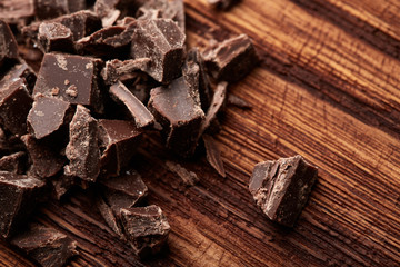 crumbs of black chocolate on a wooden background