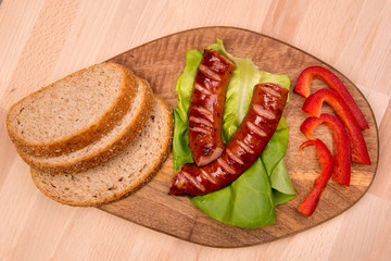 breakfast with sausage on a wooden board with mango