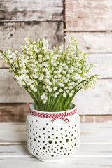 Lily of the Valley Bouquet in  Vase with Pink Ribbon .Spring Flowers Background