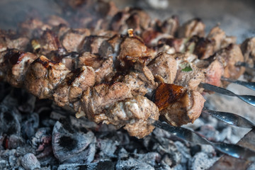 Georgian mtsvadi (Shashlik) preparation. Smoking shashlik on the grill. BBQ on Stick