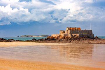 Fototapeta na wymiar Fort National and beach at low tide, in beautiful walled port city of Privateers Saint-Malo, also known as city corsaire, Brittany, France