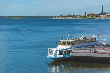 Small white boat on the big river. Ferry, ferryboat