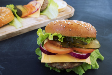 A beautiful homemade hamburger on a gray background