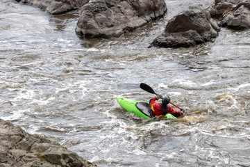one man floated in a kayak on the river