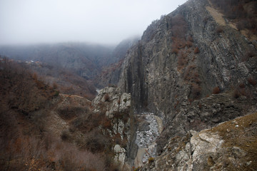 Panorama of the foggy winter landscape in the mountains with snow and rocks, Azerbaijan, Lahic, Big Caucasus