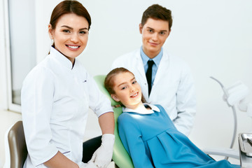 Fototapeta premium Stomatology. Dentistry Doctors And Patient In Dentist Office