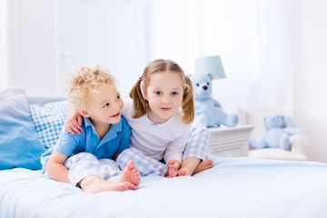 Kids playing in white bedroom