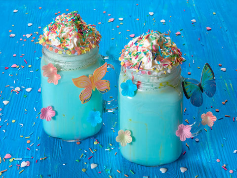 Blue unicorn hot chocolate with whipped cream, sugar and sprinkles