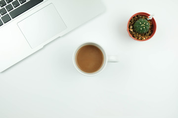 Creative flat lay design of workspace desk with laptop, cactus and coffee.
