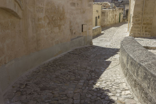 Fototapeta Ancient pebbles street in Matera historic Sassi district