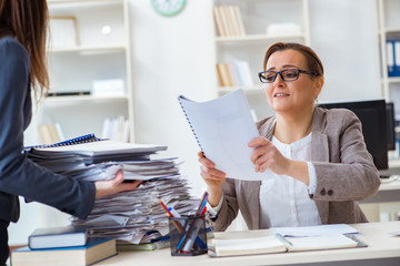 Businesswoman very busy with ongoing paperwork