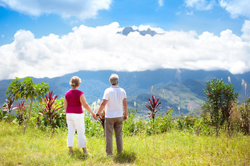 Fototapeta na wymiar Senior couple hiking in mountains and jungle