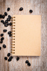 Blank vintage notebook with coffee beans.