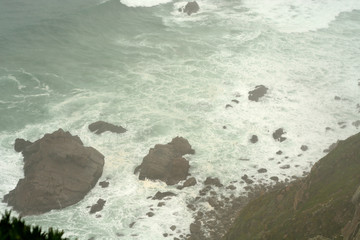Surf in the mist, cape Roca, Portugal