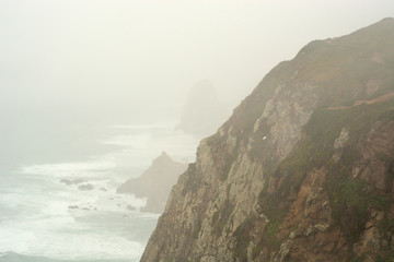 Surf in the mist, cape Roca, Portugal