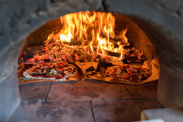 Pizza oven with flame, fire and pizzas
