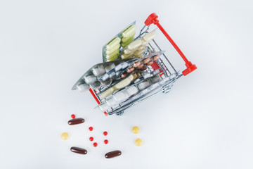 medicines in mini market Trolley. White background covered