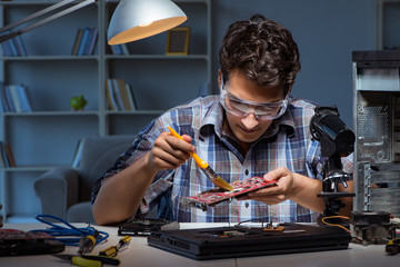 Computer repair man cleaning dust with brush 