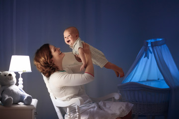 Mother and baby in dark bedroom