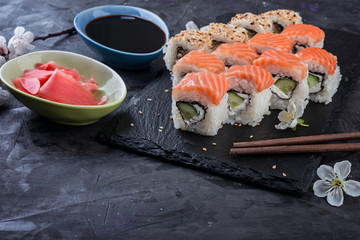 Philadelphia rolls  with salmon,  avocado, eel on stone black background.  Sushi rolls, japanese food.