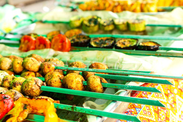 Grilled vegetables on skewers lies on a table. Traditional food for a picnic.