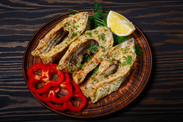 Fried fish in clay plate