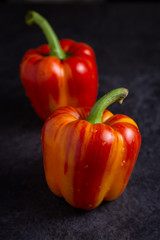 Red-yellow peppers on dark surface