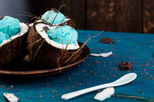 Blue ice cream in coconut bowl.