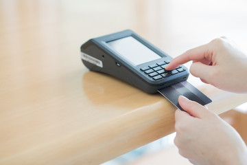 Close-up of a person using a credit card payment system
