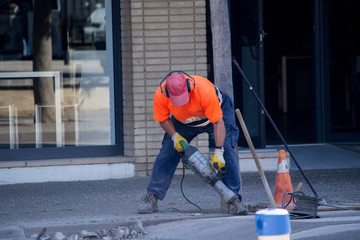 Workers repair the road.