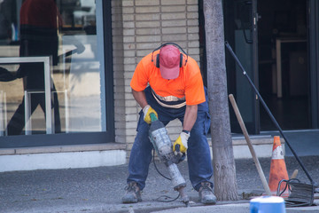 Workers repair the road.