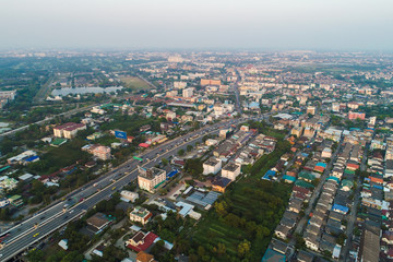 Fototapeta na wymiar City building with road aerial view in sunset