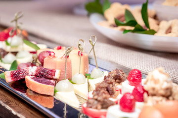 assorted appetizer set on a table with blurry background for banquet or wedding reception