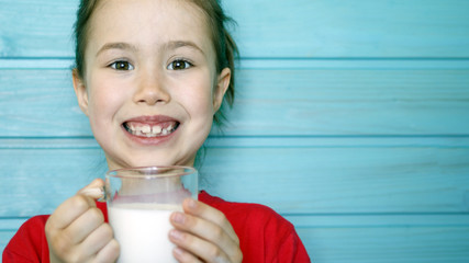 Cute little girl enjoys the taste of fresh milk