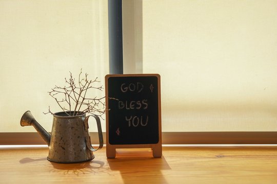 Congratulatory message on a piece of the blackboard on the wooden table under the light warm