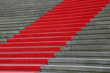 Red carpet over concrete stairs perspective