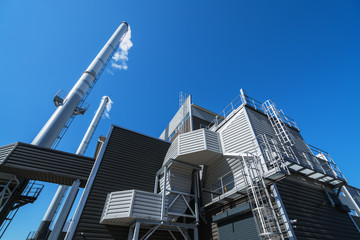 Boiler chimneys on a blue sky background