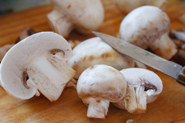 Champignon mushrooms, sacking mat and spices on wooden background